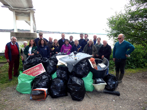 Volunteers and staff from the Wye & Usk Foundation, Keep Wales Tidy, Marine Conservation Society, the Wye Preservation Trust, Angling Trust, Wye Valley Area of Outstanding Natural Beauty with the haul of litter from the final day's clean up underneath the old Severn Bridge.