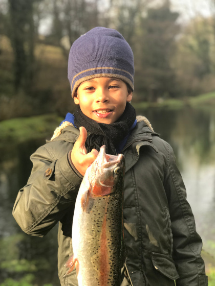 Grandson Eddie with his first trout